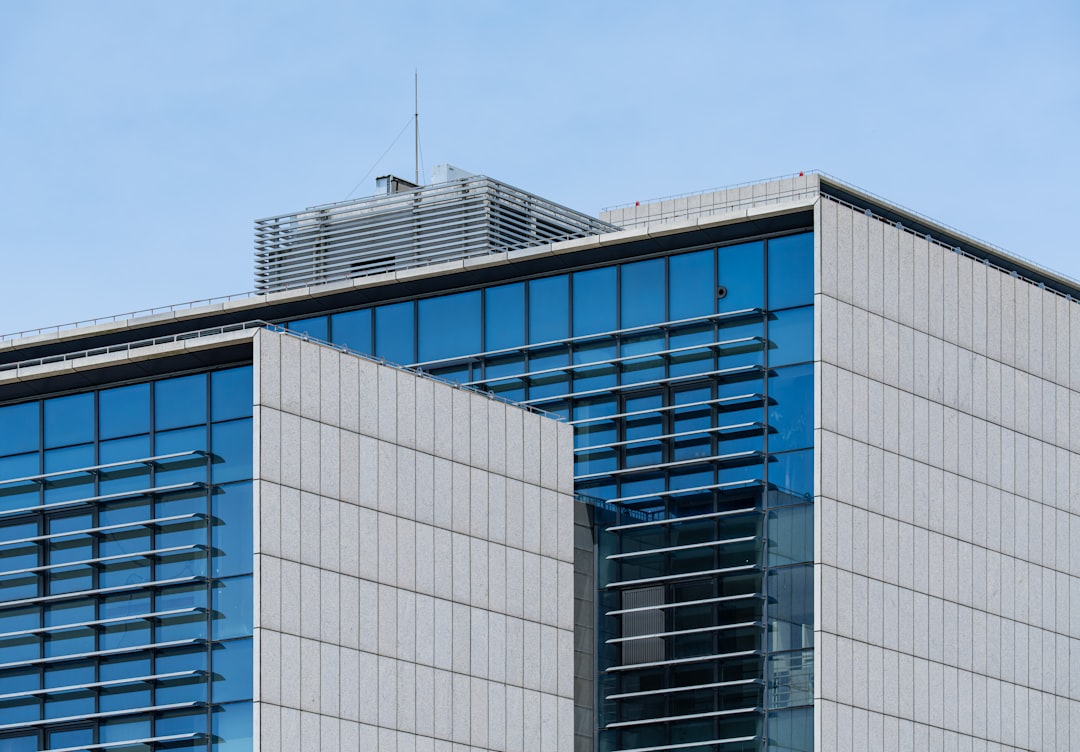 Modern glass building with blue sky background