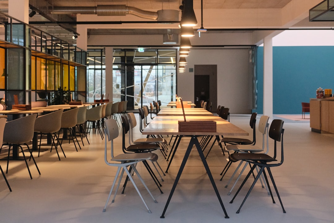 Modern dining area with long tables and chairs.